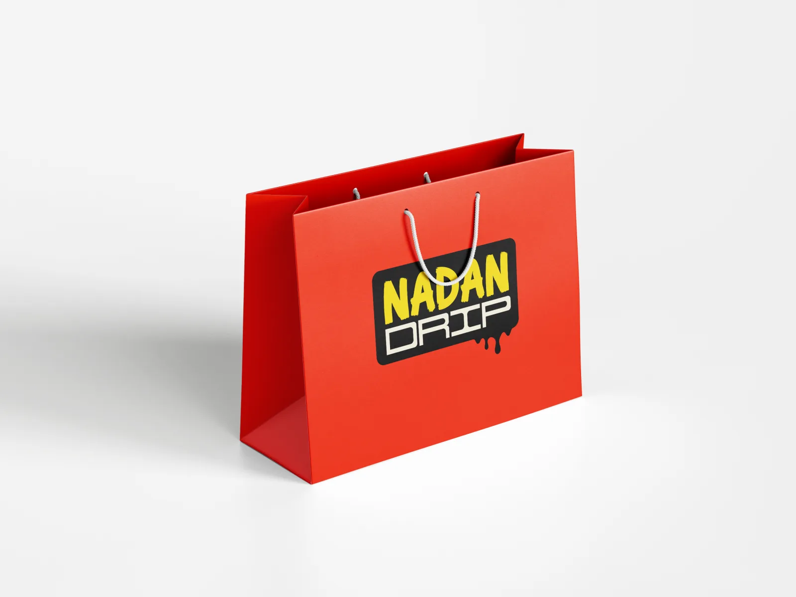 A red Nadan Drip shopping bag with rope handles